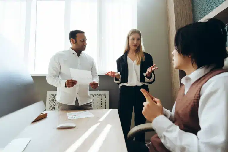 About 8 Marketing team discussing new strategy during office meeting